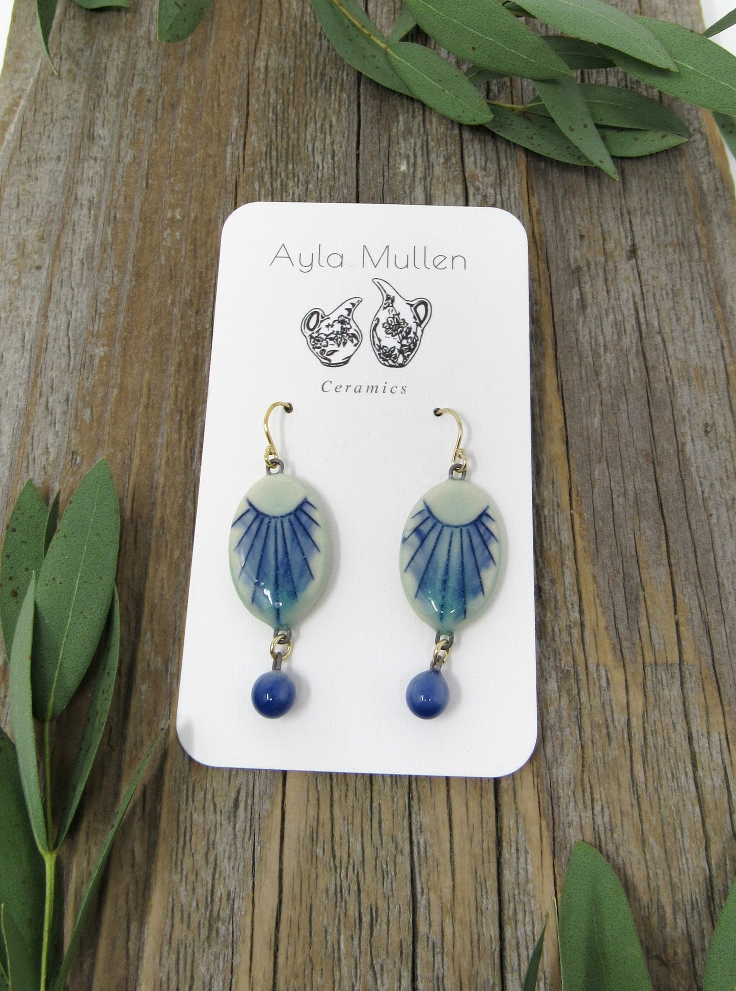 Small Oval Sunburst Earrings with Blue Dangles