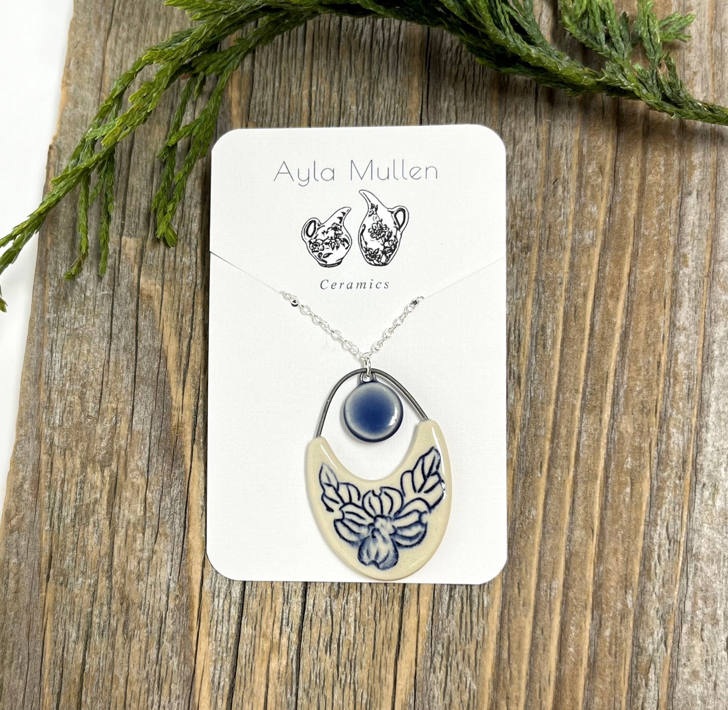 Dogwood Cutout Pendant with cobalt drop