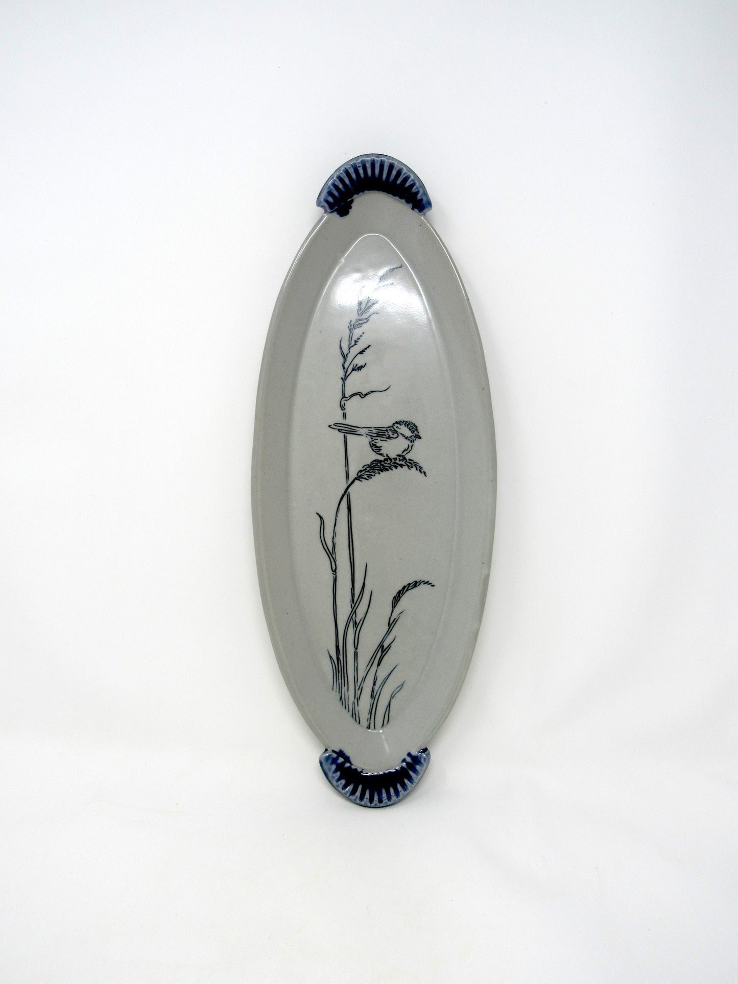 Oval Chickadee in the Grass Tray