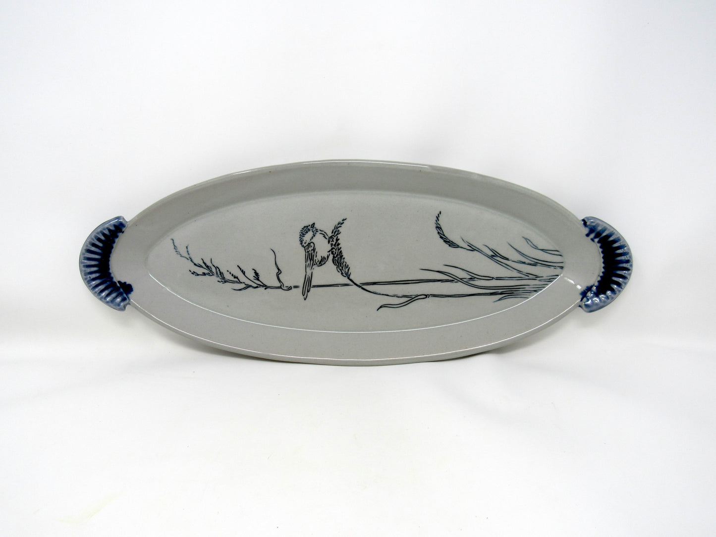 Oval Chickadee in the Grass Tray